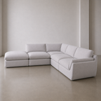 B2-S001 five piece corner modular sofa in light grey linen, left facing ottoman, three quarter view.